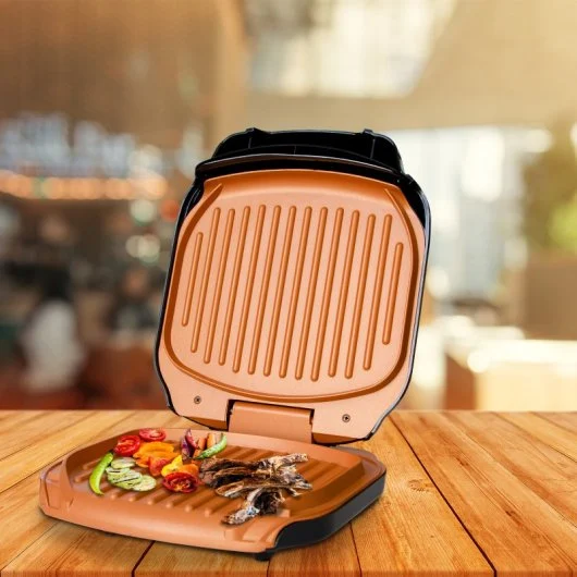 Grill électrique multifonction pour cuisine rapide - fingodor.com Grill de table ouvert avec viandes et légumes en cuisson dans un décor cuisine.