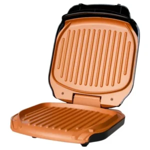 Grill électrique vide, plaques ouvertes avec surface rainurée cuivrée.